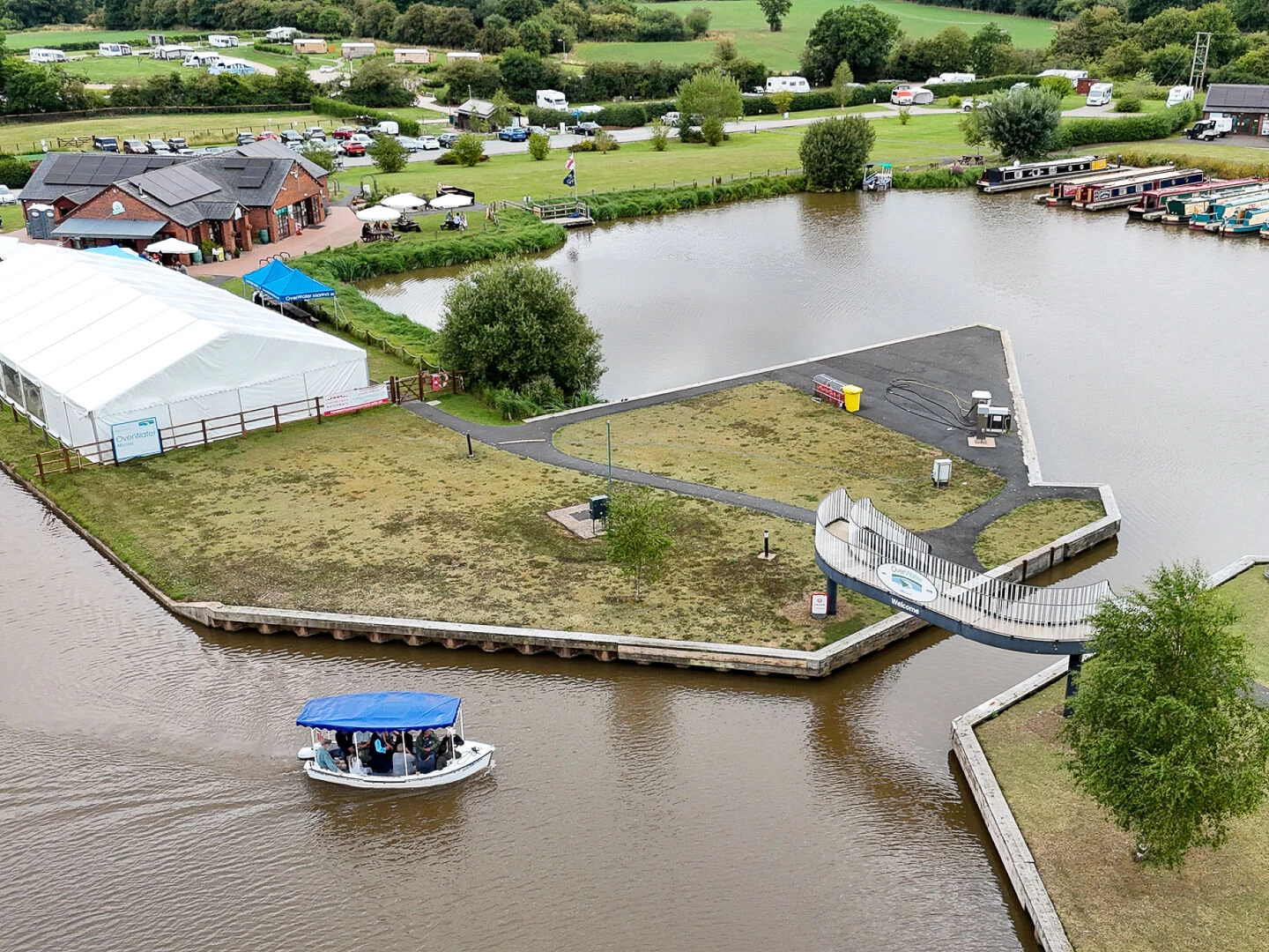 audlem lass approaches overwater marina and cafe at bridge 80