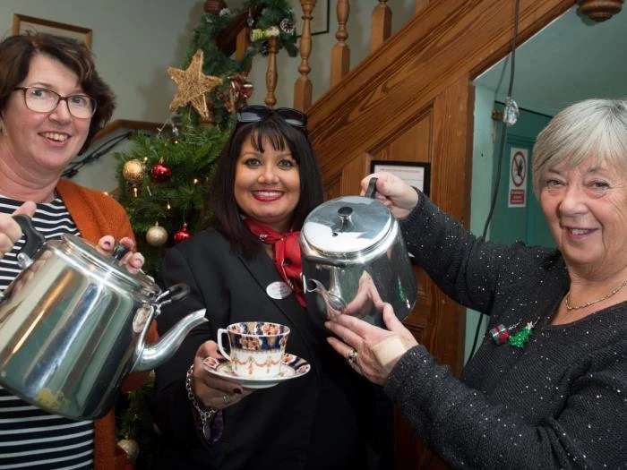 barbour institute tattenhallcommunity association secretary carole hornby redrow homes sales consultant anita gillespie and community association chair of trustees patricia black with the teapots purchased with a donation from redrow homescredit