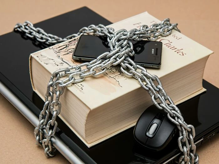 Black Android Smartphone on Top of White Book