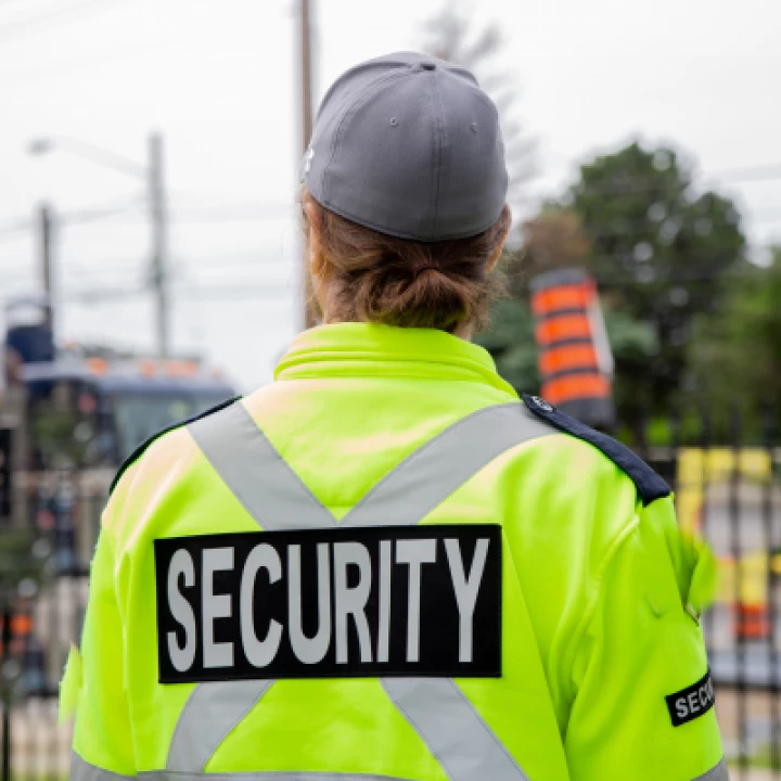 Woman in yellow security jacket