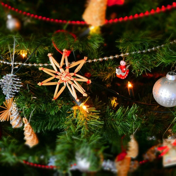 Close-up of a decorated Christmas tree with lights and ornaments, showcasing holiday spirit.