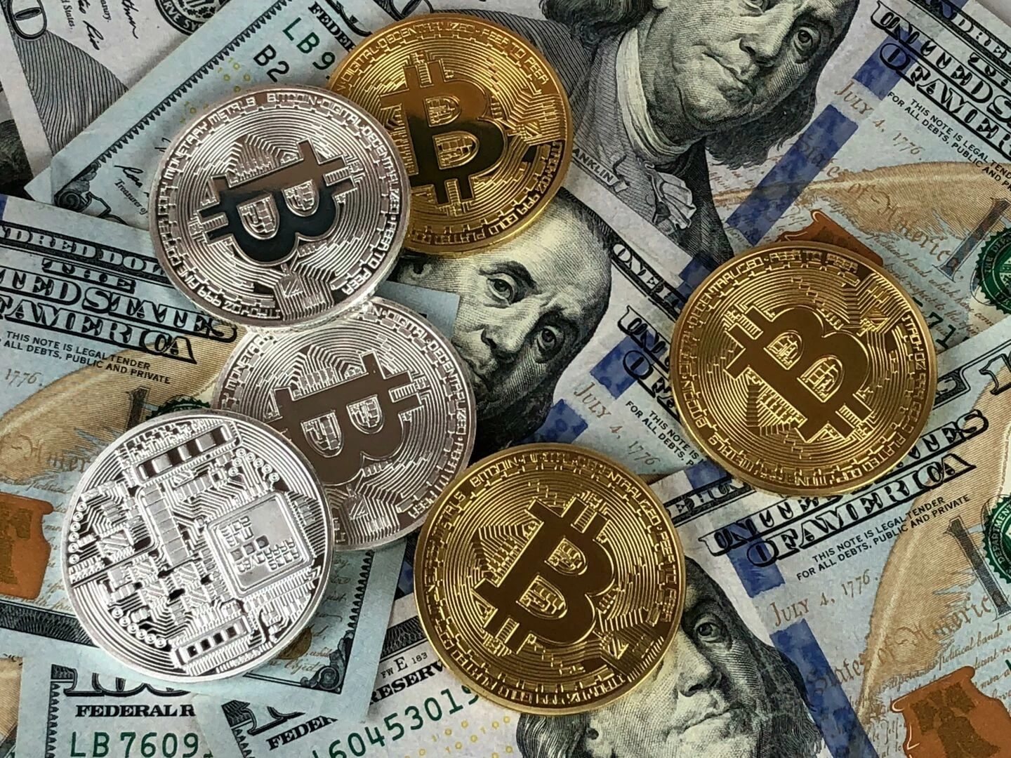 closeup of bitcoins and us dollar bills symbolizing modern finance and cryptocurrency