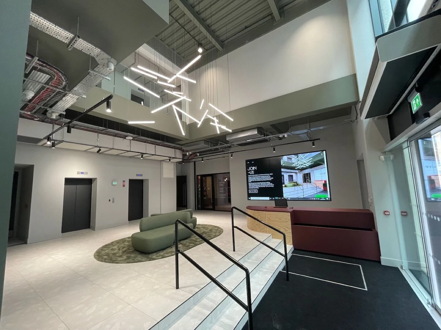 modern office lobby with staircase and screen