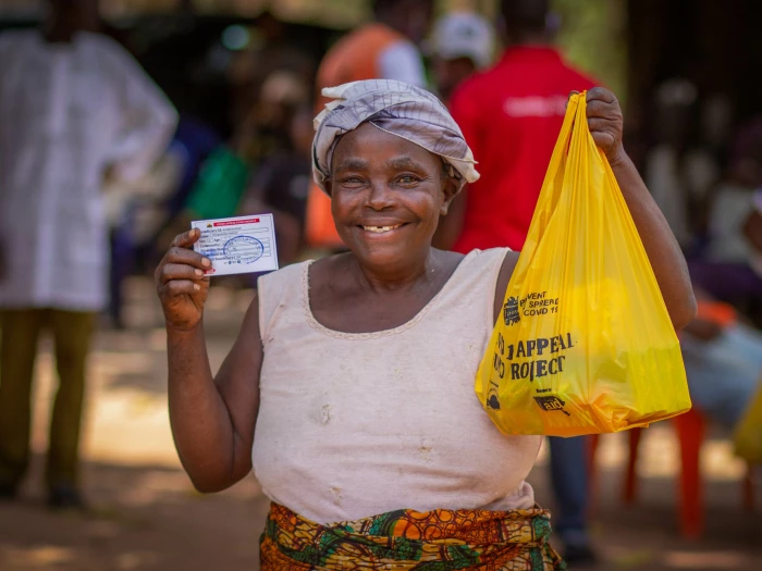 photo  a woman very happy to collect her hygiene kit at an aid distribution funded by christian aids covid appeal in adagi community benue state nigeria