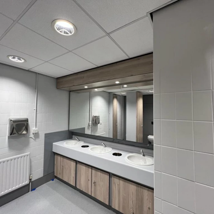 refurbished washroom at qbe leeds with mirrors and basins
