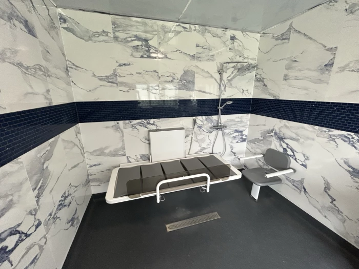 the ropox mobile showerchanging bed is height adjustable