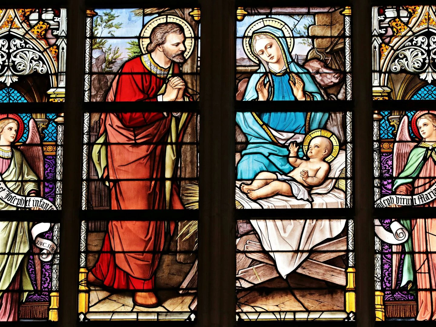 vibrant stained glass window illustrating a biblical nativity scene with vivid colors in a church setting