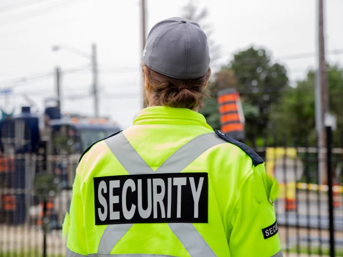 woman in yellow security jacket