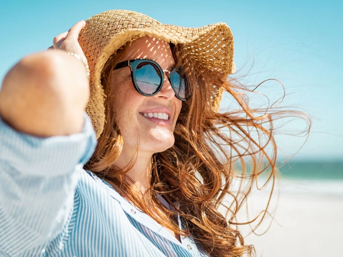 woman wearing sunglasses and straw hat
